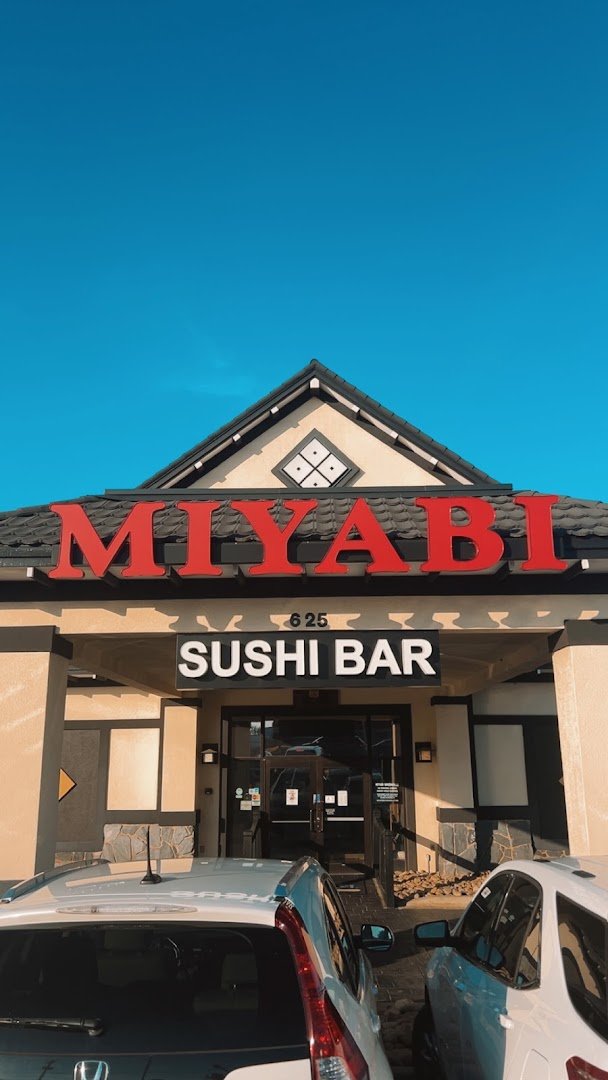 Hibachi grill with plated Japanese steakhouse dishes.