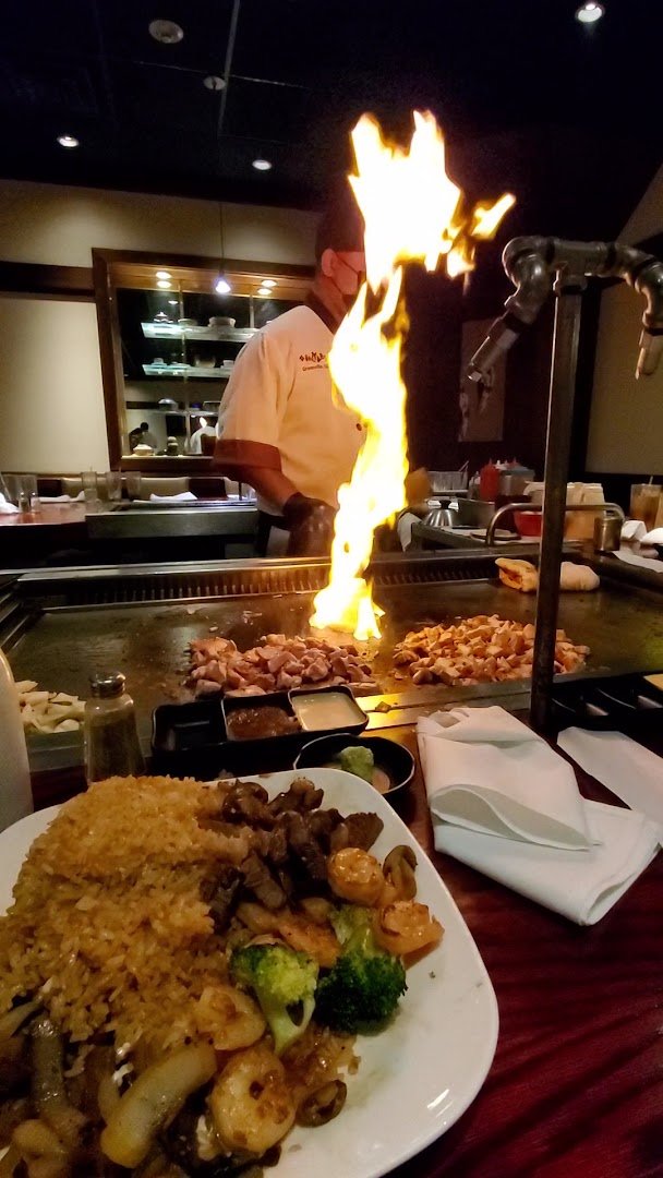 Seafood and steak entrées served on white plates.
